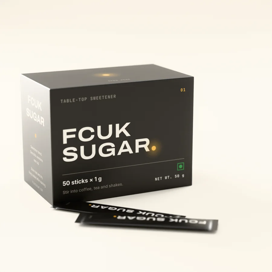 FCUK SUGAR stick carton in matte black with loose stick sachets.